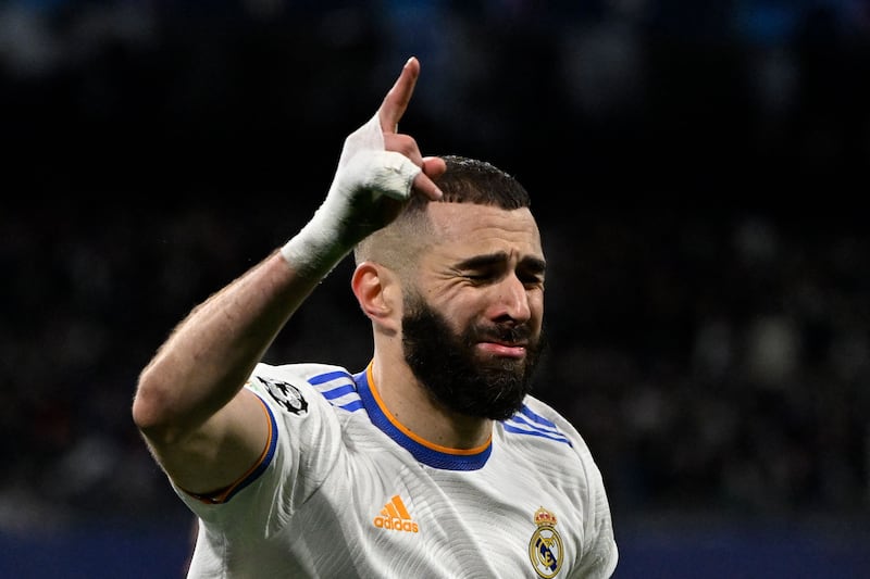Karim Benzema celebrates scoring Real Madrid's second goal against Chelsea to earn his team a place in the Champions League semi-finals 5-4 on aggregate despite losing 3-2 on the night. AFP