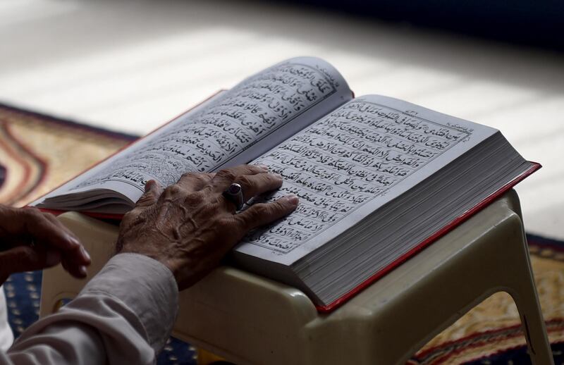 A Pakistani Muslim devotee recites the Quran at a mosque during the holy month of Ramadan in Karachi on June 13, 2016.

Islam's holy month of Ramadan is celebrated by Muslims worldwide marked by fasting, abstaining from foods, sex and smoking from dawn to dusk for soul cleansing and strengthening the spiritual bond between them and the Almighty. / AFP PHOTO / RIZWAN TABASSUM