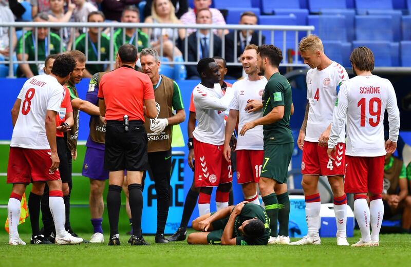 Australia's Andrew Nabbout is on the floor after sustaining an injury as Denmark's Christian Eriksen looks on. Dylan Martinez / Reuters