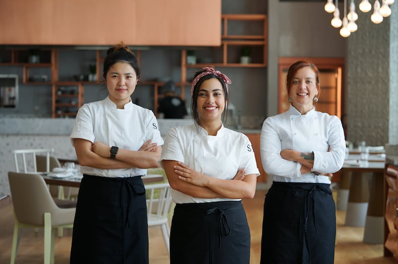 Chef Sara Aqel, centre, heads up Dubai restaurant Fi'lia's female-led kitchen