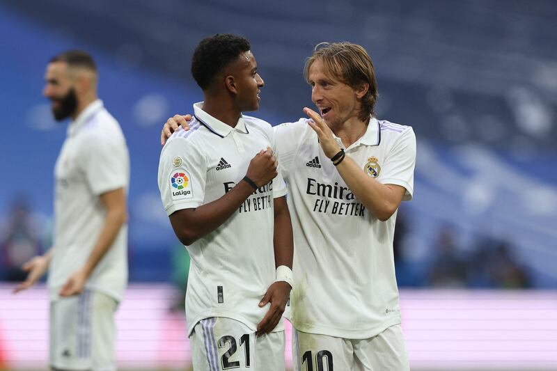 Rodrygo celebrates with Luka Modric at the end of the match. AFP