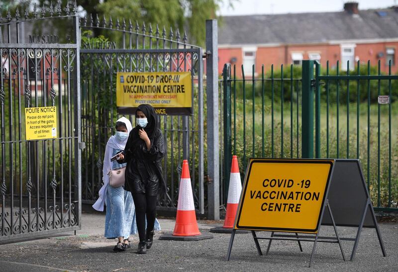 People leave a vaccination centre set up at the Masjid-e-Saliheen mosque in Blackburn. AFP