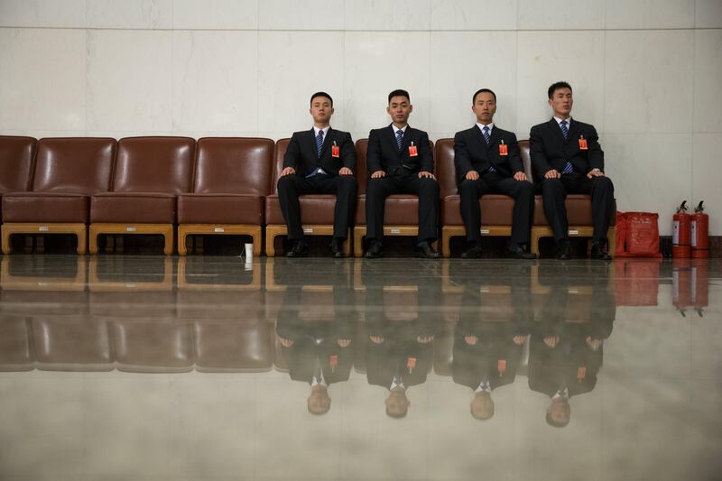 Security officers are reflected in the shining floor during the closing ceremony of the 19th National Congress of the Communist Party of China (CPC) in Beijing. Roman Pilipey / EPA