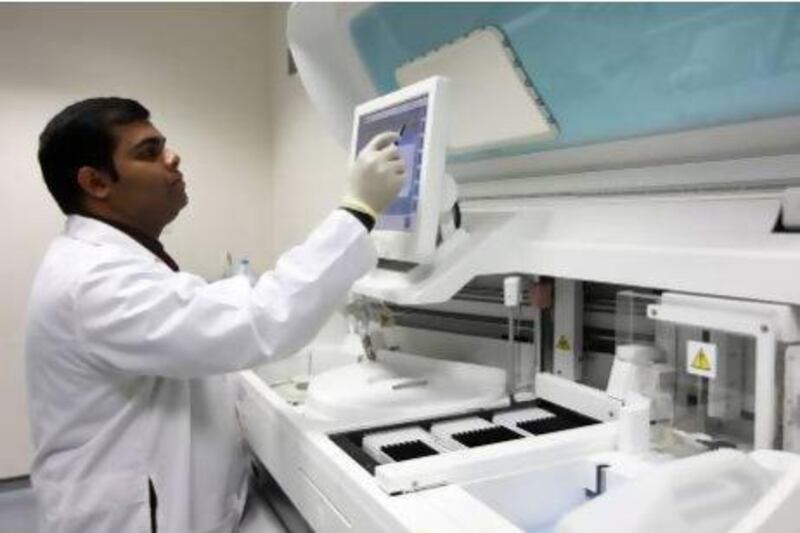 A lab technician working in the XY clinics lab in Al Barsha, Dubai. Pawan Singh / The National