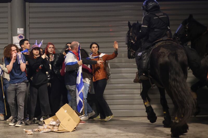 Mounted police disperse protesters in Tel Aviv. AP
