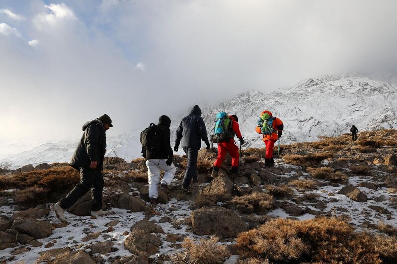 Members of emergency and rescue team search for the plane that crashed in a mountainous area of central Iran. Tasnim News Agency / Reuters