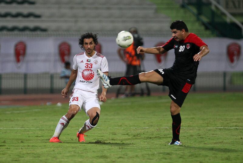 DUBAI , UNITED ARAB EMIRATES Ð Sep 14 :  Bader ( no 33 in white ) of Sharjah and Neaster ( no 20 ) of Emirates in action during the Pro League round robin tournament football match between Sharjah vs Emirates at Al Shabab stadium in Dubai. Important Please check the name of Emirates player.  ( Pawan Singh / The National ) For Sports. Story by Ahmed