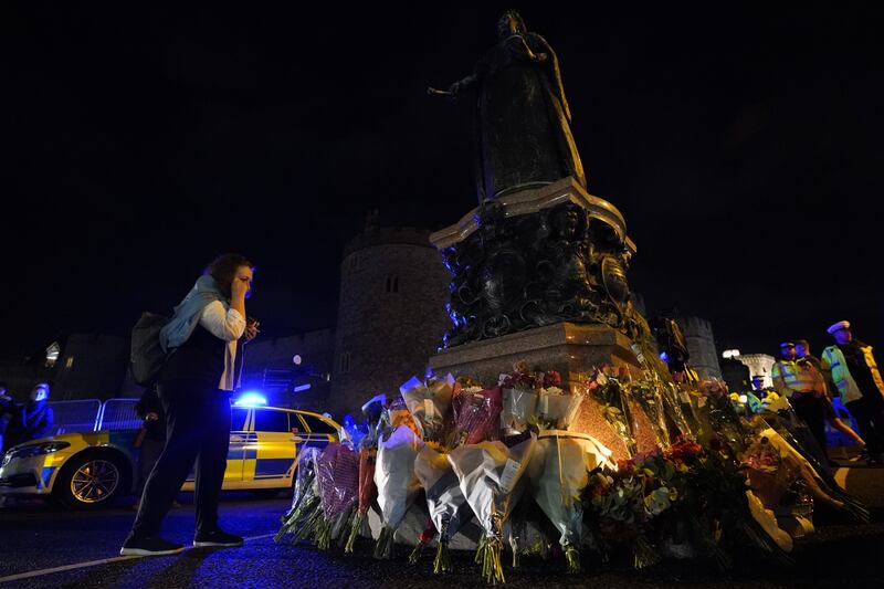 Flowers are left under the Queen Victoria statue outside Windsor Castle. PA