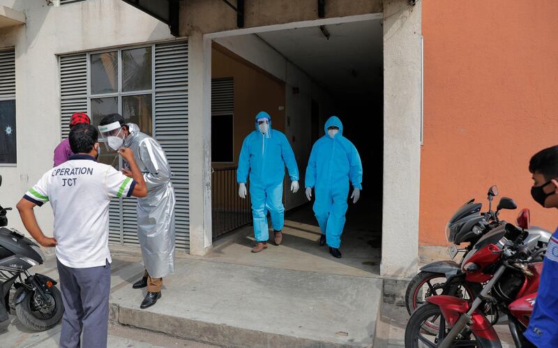 Sri Lankan health officials inspect a housing complex as they prepare to collect swab samples to test for COVID-19 in Colombo, Sri Lanka, Monday, Nov. 23, 2020. (AP Photo/Eranga Jayawardena)