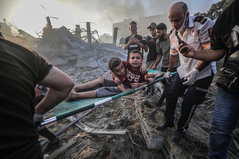 Two brothers on a stretcher after being rescued from beneath the rubble of a destroyed area in Gaza. EPA
