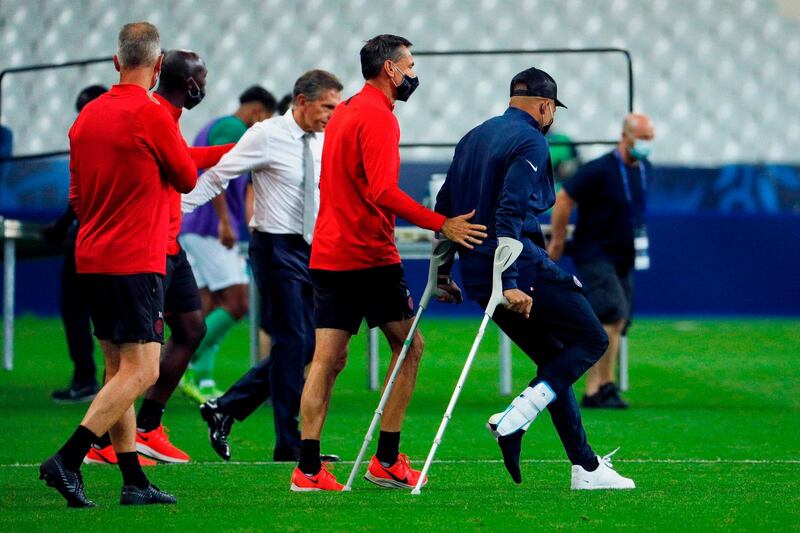 Kylian Mbappe walks with crutches. AFP