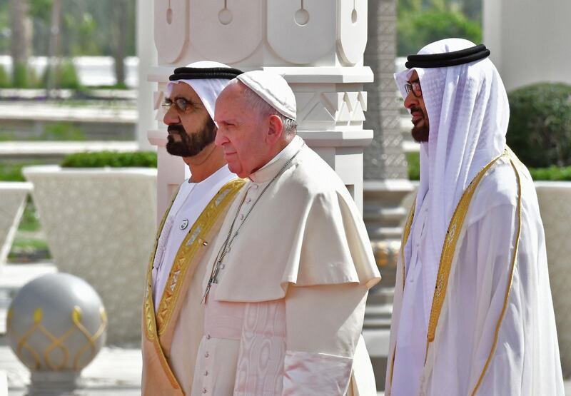 Pope Francis is welcomed by Sheikh Mohammed bin Rashid and Sheikh Mohamed bin Zayed at the Presidential Palace in Abu Dhabi. AFP / Giuseppe Cacace