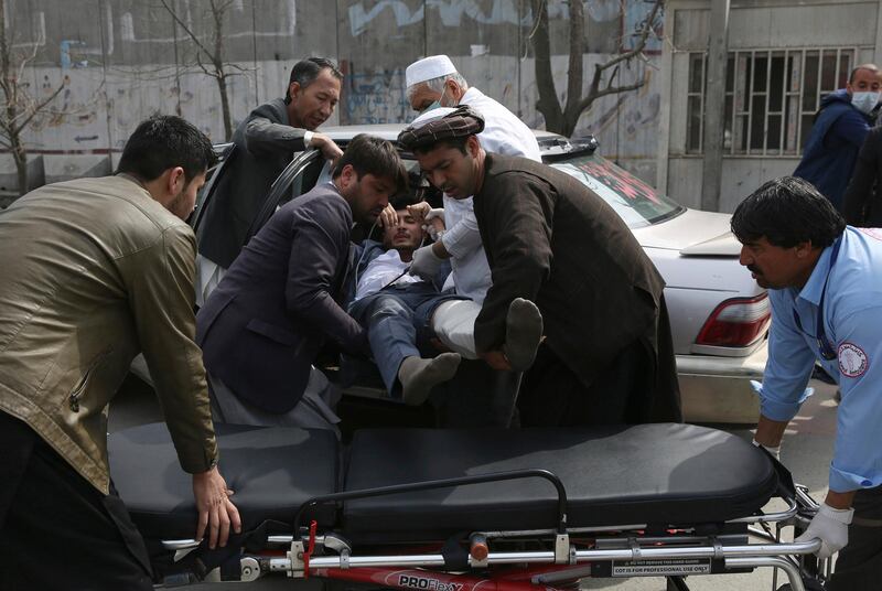 An injured man is carried into an ambulance after an attack in Kabul, Afghanistan. AP Photo