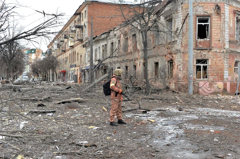 A member of the Ukrainian Territorial Defence Forces in a street after Russian shelling in Kharkiv, Ukraine's second-biggest city. AFP