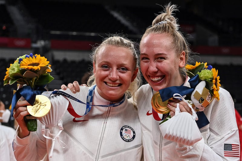 USA's Jordyn Poulter and Michelle Bartsch-Hackley pose with their gold medals during the women's volleyball victory ceremon.