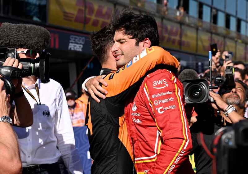 Carlos Sainz embraces McLaren's Lando Norris after both drivers finished on the podium. Reuters