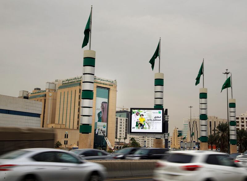 Vehicles pass in front of a screen advertising Saudi Arabia's state-owned oil company Aramco with Arabic reads, "promising future" in Riyadh. AP Photo