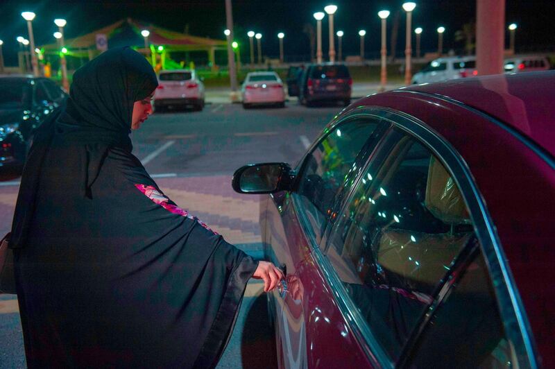 Sabika Habib gets ready to drive her car through the streets of Khobar City on her way to Bahrain. Hussain Radwan / AFP