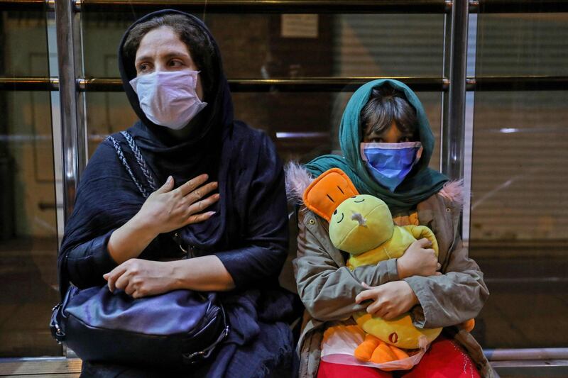 Iranians wearing masks gather outside their buildings after a 5.1-magnitude earthquake was felt in the capital Tehran. AFP / ISNA