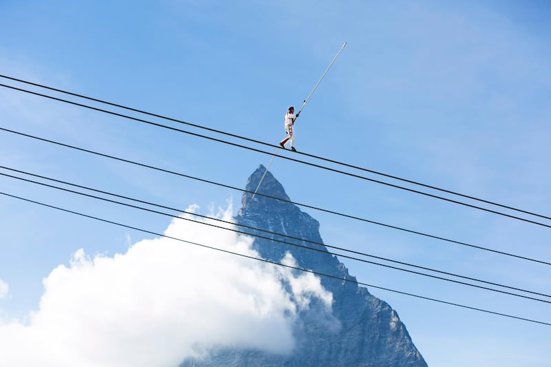 Freddy Nock, tightrope walker, tackles a rope in front of the Matterhorn mountain during the inauguration ceremony of the new 3S ropeway in Zermatt, Valais, Switzerland. EPA