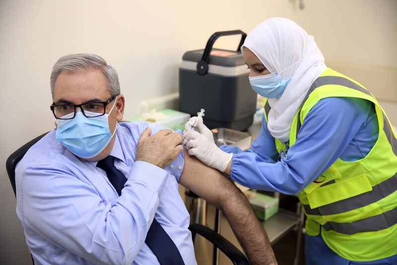 Jean Jabbour, WHO representative to Oman, receives his first dose of the Pfizer-BioNTech Covid-19 vaccine in the Omani capital Muscat.  AFP