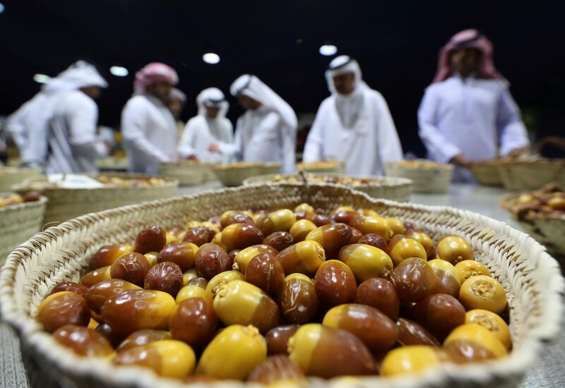 Judges discuss the quality of Dabbas dates during a completion on the opening day of the Liwa Dates Festival. AP