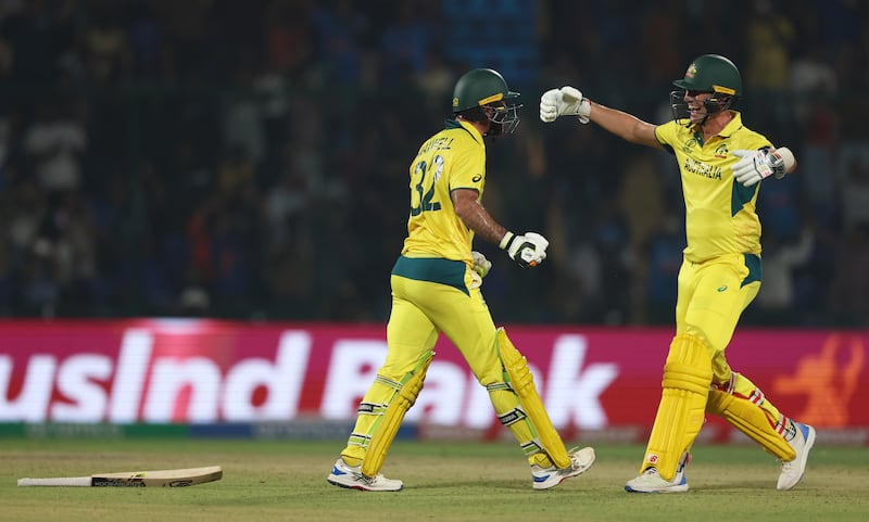 Glenn Maxwell of Australia celebrates his century with teammate Pat Cummins. Australia reached 399-8 in their innings. Getty Images