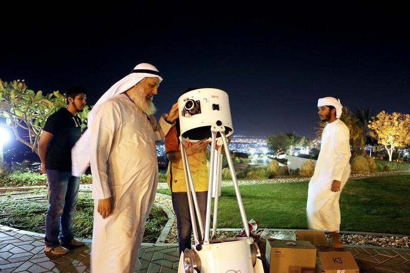 Hasan Ahmad Al Hariri from thee Dubai Astronomy Group sets up his telescope. Pawan Singh / The National