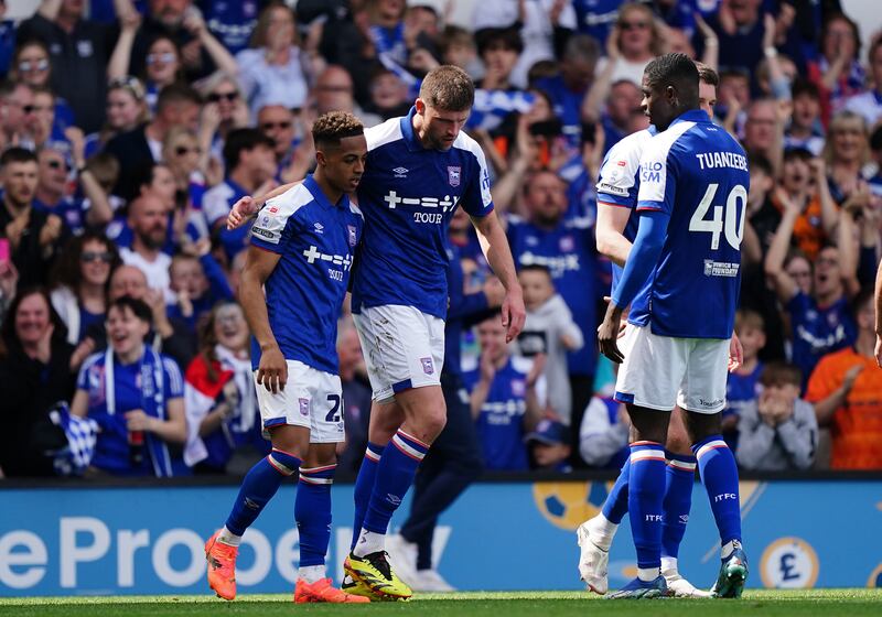 Ipswich Town's Omari Hutchinson, left, celebrates with teammates after scoring their second goal. PA 