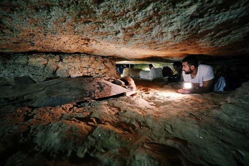 Egyptian antiquities worker is seen inside the recently discovered burial site in Minya, Egypt. Mohamed Abd El Ghany / Reuters
