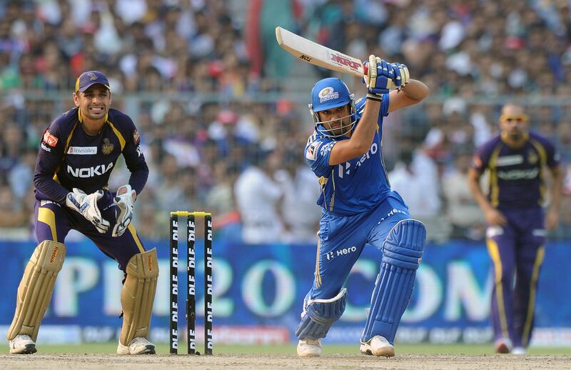 Mumbai Indians batsman Rohit Sharma is watched by Kolkata Knight Riders wicketkeeper Manvinder Bisla as he plays a shot during the IPL Twenty20 cricket match between Kolkata Knight Riders and Mumbai Indians at The Eden Gardens in Kolkata on May 12, 2012.  RESTRICTED TO EDITORIAL USE. MOBILE USE WITHIN NEWS PACKAGE.  AFP PHOTO/Dibyangshu SARKAR