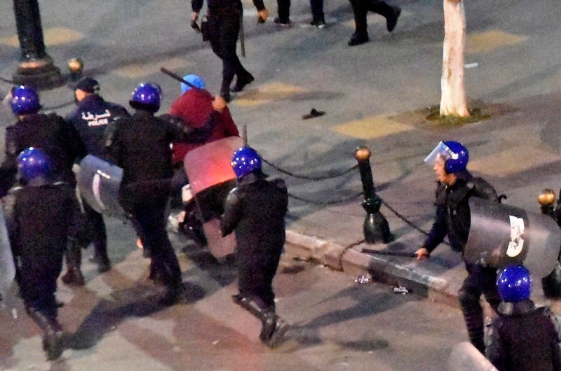 Algerian security forces rush towards demonstrators during an anti-government demonstration on, in the capital Algiers on the day of the presidential election. About 10,000 protesters rallied in Algeria's capital against presidential elections they believe aim to perpetuate the regime of deposed leader Abdelaziz Bouteflika, AFP reporters witnessed. AFP