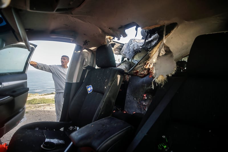 The group's car was hit after leaving a warehouse in Deir Al Balah, despite co-ordinating its movements with the Israeli military. EPA