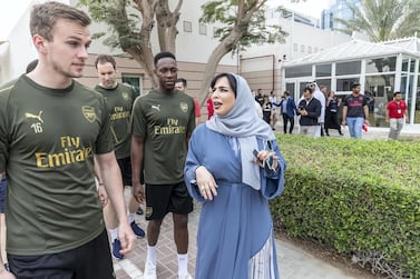 Mariam Othman escorts Arsenal FC and Al Nasr players around the centre