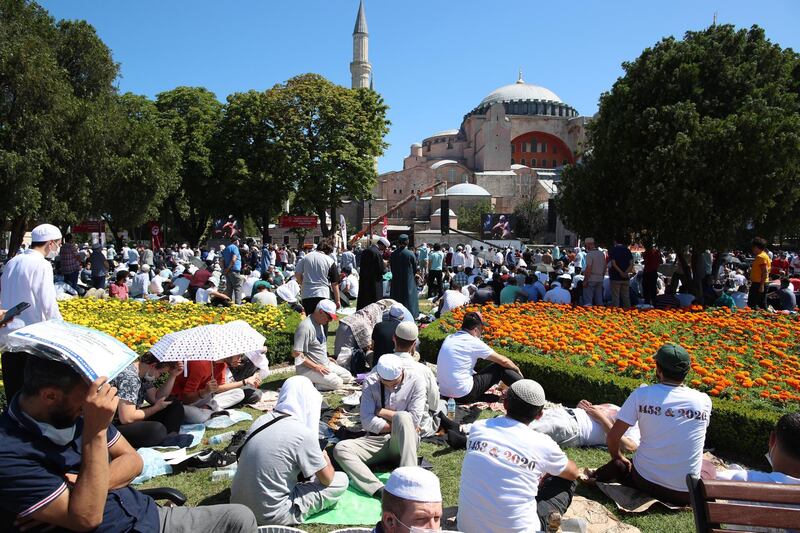 People wait for the first Friday prayers during the official opening ceremony of Hagia Sophia as a mosque in Istanbul, Turkey.  EPA