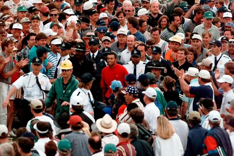 Tiger Woods is engulfed by the gallery as he makes his way to the the 18th hole during final round at the 1997 US Masters. AP Photo