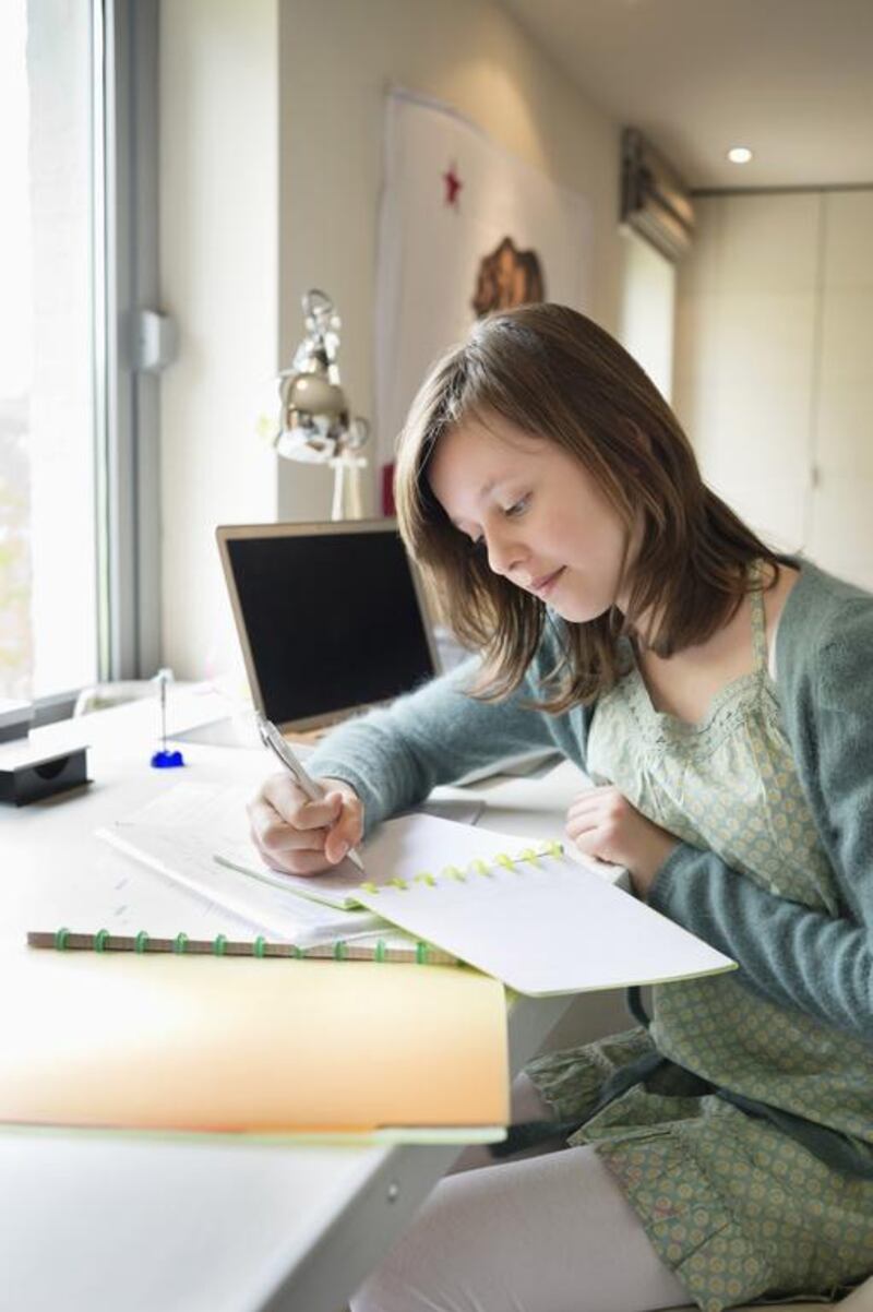 Encouraging your child to keep a journal is one way to get them back into the habit of writing regularly. Eric Audras/Onoky/Corbis