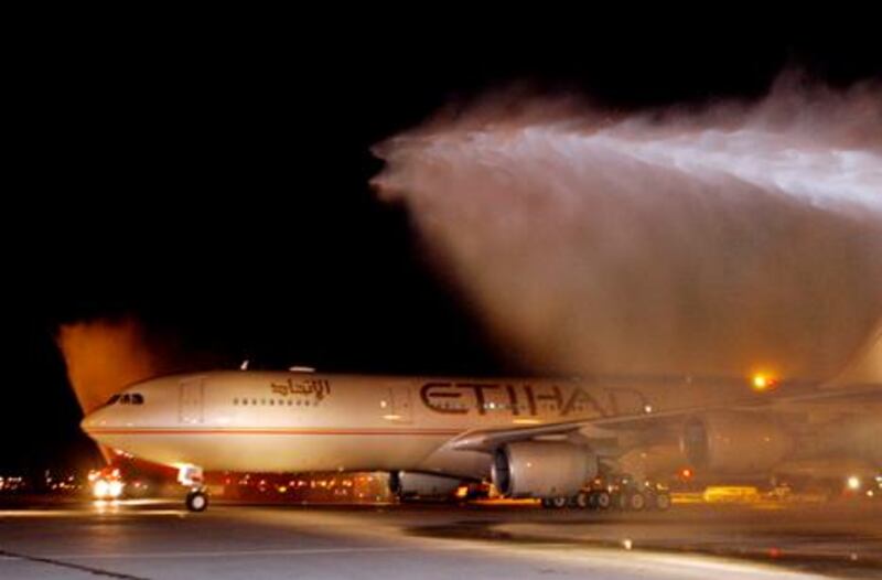 Etihad Airways Flight EY503 is welcomed with spraying water from two fire trucks as the flight arrives at John F. Kennedy Airport in New York October 26, 2006. The United Arab Emirates-based airline inaugurated daily non-stop service from Abu Dhabi with the flight. REUTERS/Etihad Airways/Ray Stubblebine/HO