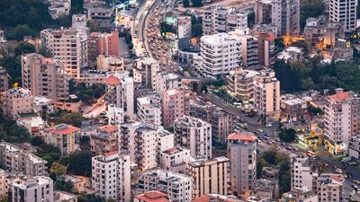 An image overlooking a part of the busy highway between Beirut and Jouniyeh, this highway goes through residential and commercial areas, a tableau of colourful and illuminated area in the early evening. Getty Images