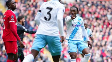 Crystal Palace's Eberechi Eze, right, celebrates after scoring his side's opening goal during the English Premier League soccer match between Liverpool and Crystal Palace at Anfield Stadium in Liverpool, England, Sunday, April 14, 2024.  (AP Photo / Jon Super)