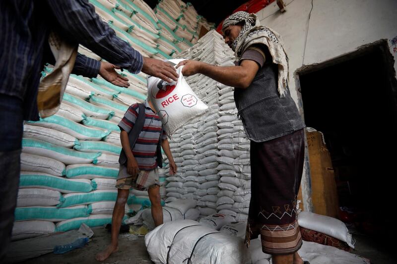 epa08557151 Men work inside a grain warehouse in Sana'a, Yemen, 19 July 2020 (issued 20 July 2020). According to reports, an estimated 24 million Yemenis – roughly 80 percent of the country's total population – are in dire need of immediate humanitarian assistance. Meanwhile, the United Nation's World Food Program (WFP) has been forced to cut its food rations for up to 8.5 million people in the Houthi-controlled northern areas of the war-ridden nation due to a lack of funds and donations.  EPA/YAHYA ARHAB