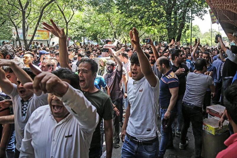 A group of protesters chant slogans at the old grand bazaar in Tehran, Iran, Monday, June 25, 2018. Protesters in the Iranian capital swarmed its historic Grand Bazaar on Monday, news agencies reported, and forced shopkeepers to close their stalls in apparent anger over the Islamic Republic's troubled economy, months after similar demonstrations rocked the country. (Iranian Labor News Agency via AP)