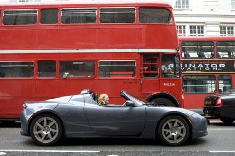 The Tesla Roadster is dwarfed by London's red double-decker buses. The little sports car is powered by 6,831 lithium ion batteries.