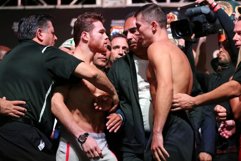 Canelo Alvarez, center left, and Gennady Golovkin face off during a weigh-in at T-Mobile Arena in Las Vegas, Friday, Sept. 14, 2018. Alvarez and Golovkin will fight Saturday night in a middleweight title bout. (Erik Verduzco/Las Vegas Review-Journal via AP)