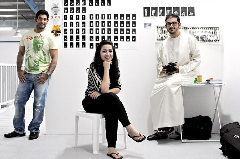 From left, the painter Bilal Aquil, the conceptual artist Rania Jishi and the photographer Ammar Alattar in the Capsule Arts warehouse. Jeff Topping for The National
