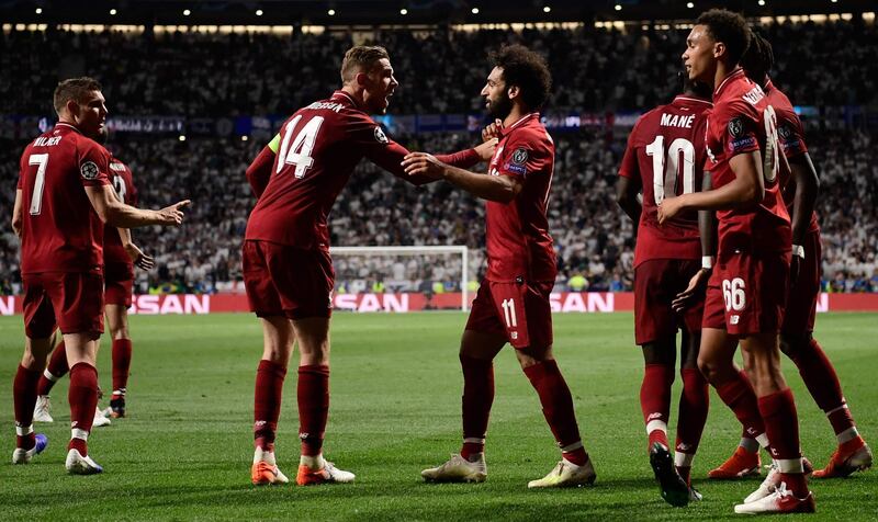 Liverpool's midfielder Jordan Henderson and Mohamed Salah celebrate after Divock Origi scored. AFP