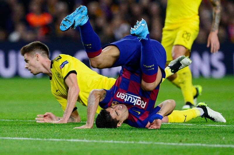 Barcelona forward Luis Suarez goes head-over-heels after a challenge by Dortmund's Julian Weigl. AFP