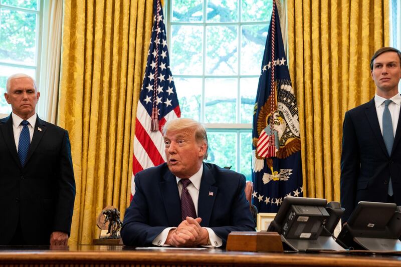 U.S. President Donald Trump speaks while Vice President Mike Pence, left, and Jared Kushner, senior White House adviser, right, listen during a press conference on Israel and Bahrain establishing full diplomatic ties in the Oval Office of the White House in Washington, D.C., U.S., on Friday, Sept. 11, 2020.  Bahrain will become the second Gulf nation to establish full diplomatic relations with Israel, joining the United Arab Emirates in normalizing ties with the Jewish state. Photographer: Anna Moneymaker/The New York Times/Bloomberg