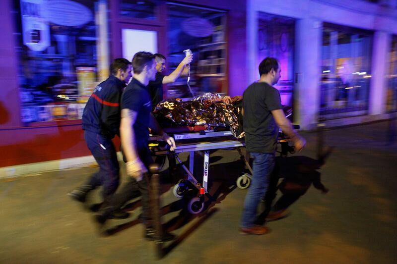 Paramedics move an injured person from the Bataclan theatre after the November 2015 attacks. AP