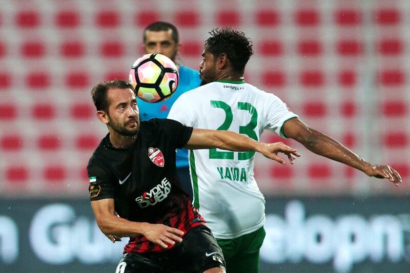 Al Ahli’s Everton Ribeiro, left, battles for the ball against Emirates’ Haidar Alo Ali during their Arabian Gulf League match on Saturday. Christopher Pike / The National